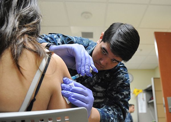 Image of military treating patient depicting medical benefits for former military spouse